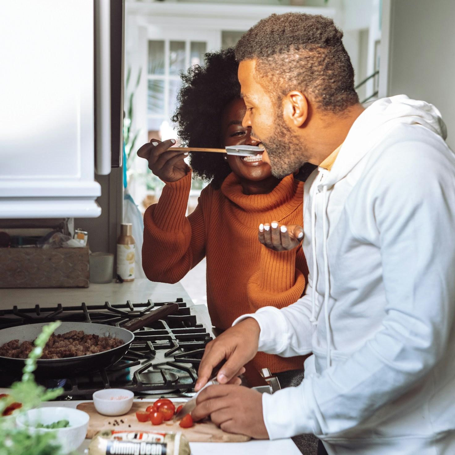 Diverse group of community members sharing a meal together, showcasing the social bonds formed through collaborative cooking