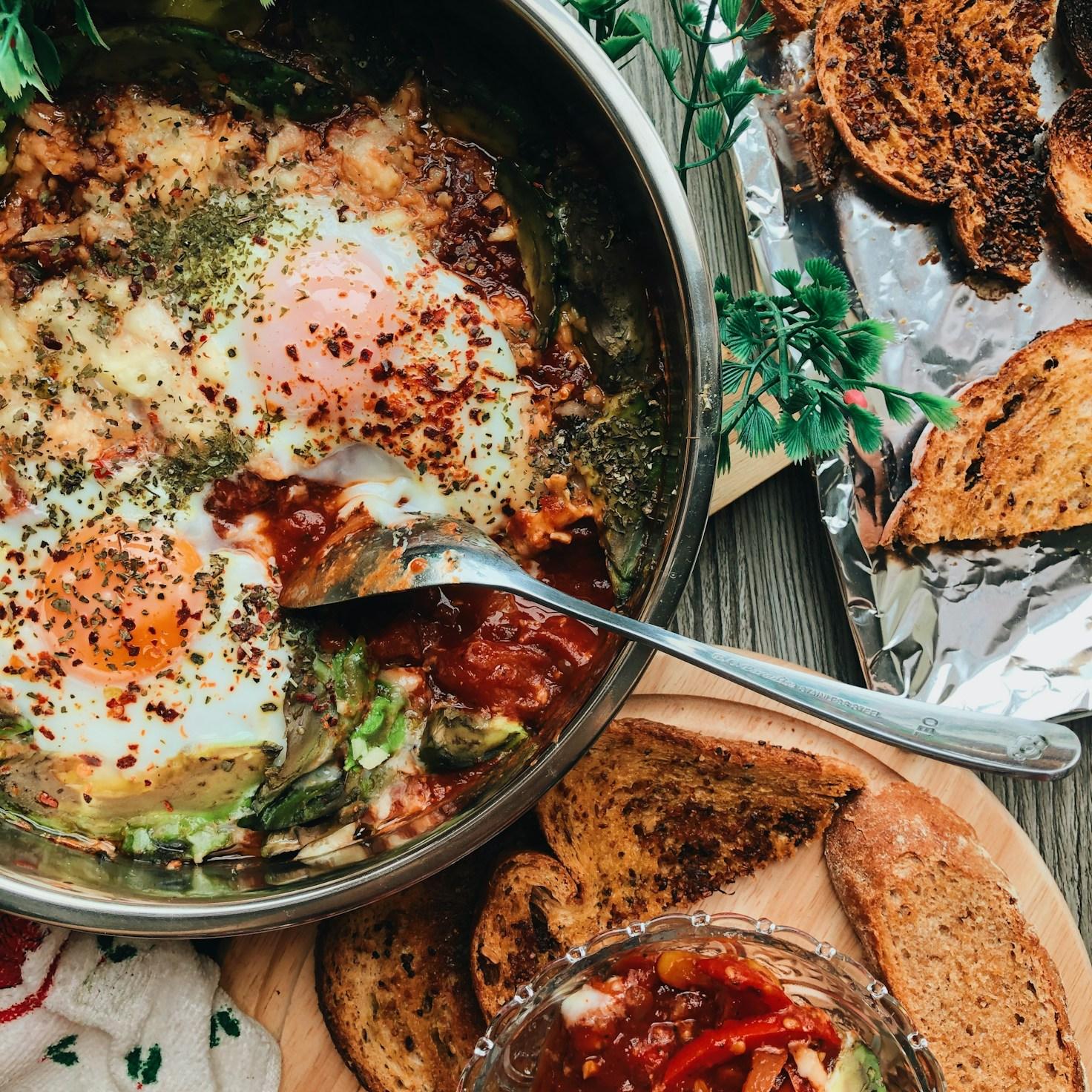 Members working together in a contemporary kitchen, exchanging recipes and cooking techniques